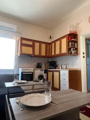 a kitchen with a wooden table with a plate on it at Ciel Apartment in Rhodes Town