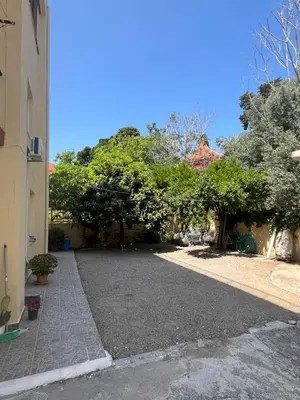 a driveway in front of a house with trees at Ciel Apartment in Rhodes Town