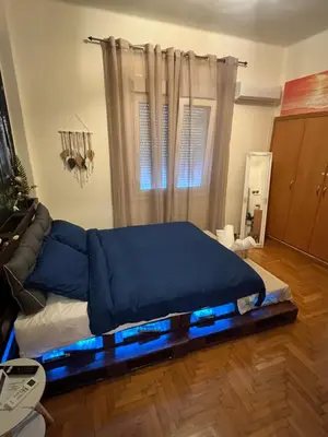 a bed in a room with a blue bed frame at Ciel Apartment in Rhodes Town