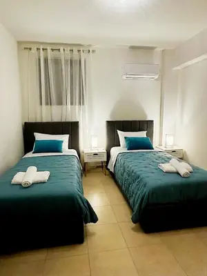 a bedroom with two beds with towels on them at Angela House in Symi