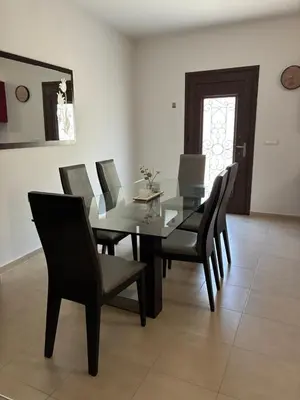 a dining room with a glass table and chairs at Angela House in Symi