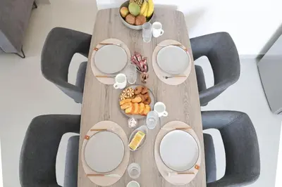 a wooden table with plates and food on it at Villa Viventia with Heated Pool in Afantou