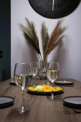 a wooden table with wine glasses and a plate of fruit at Villa Viventia with Heated Pool in Afantou