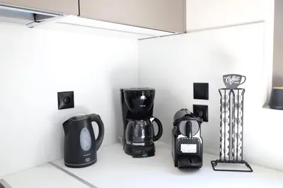 a kitchen with black appliances on a counter at Villa Viventia with Heated Pool in Afantou