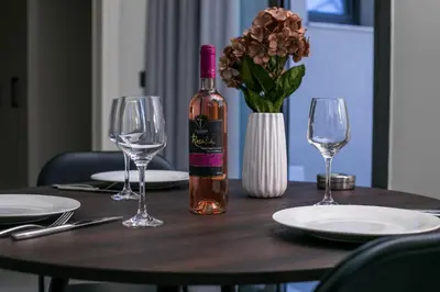 a bottle of wine sitting on a table with glasses at Blue Terra Living in Kremasti