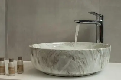 a sink with a faucet pouring water into it at Blue Terra Living in Kremasti
