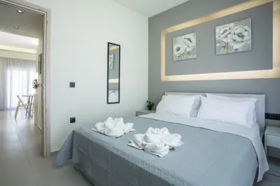 a bedroom with a bed with two towels on it at Blue Terra Living in Kremasti