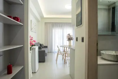 a kitchen and a living room with a sink at Blue Terra Living in Kremasti