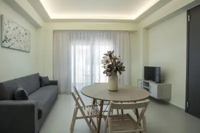 a living room with a table with a vase of flowers on it at Blue Terra Living in Kremasti