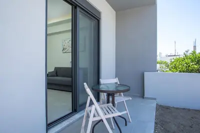 a small table and two chairs on a balcony at Blue Terra Living in Kremasti