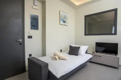 a bedroom with a bed and a flat screen tv at Blue Terra Living in Kremasti