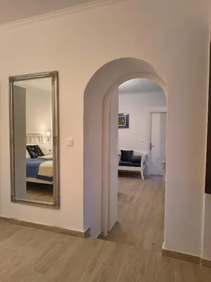 a bedroom with a mirror and a bed in a room at Lirenou Scala Vista in Symi