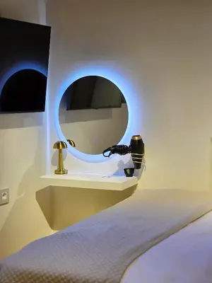 a bedroom with a round mirror and a bed at Barbarian in Rhodes Town