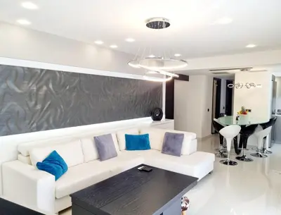 a living room with a white couch and blue pillows at Casa di Jiovanni Luxury in Asgourou