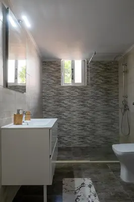 a bathroom with a sink and a toilet at Filerimos Nest in Pastida
