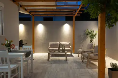 a patio with a table and chairs and a table and chairsearcher at Filerimos Nest in Pastida