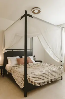 a bedroom with a large bed with a canopy at Pura Vida Beach House in Kiotari