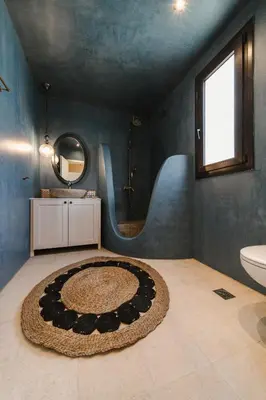 a bathroom with a sink and a toilet and a mirror at Pura Vida Beach House in Kiotari