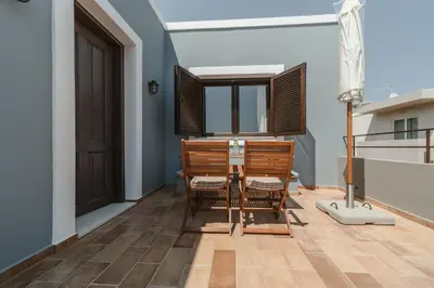 a dining room with a table and a window at Pura Vida Beach House in Kiotari