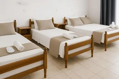 a group of four beds in a room at Melpos Room in Kremasti