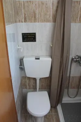 a bathroom with a toilet and a shower at Melpos Room in Kremasti