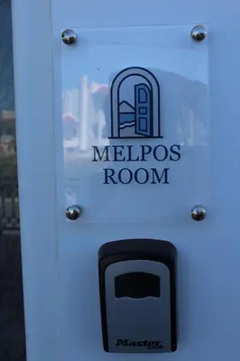 a sign for a melopedros room with a cell phone at Melpos Room in Kremasti