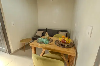 a table with a bowl of fruit and a couch at Christos studios and family apartments in Vrachonisída touArchangélou