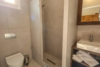 a bathroom with a shower and a toilet and a sink at Christos studios and family apartments in Vrachonisída touArchangélou