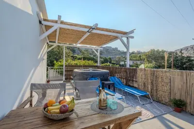 a table with a basket of fruit on a patio at Christos studios and family apartments in Vrachonisída touArchangélou