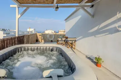 a hot tub on the side of a building at Christos studios and family apartments in Vrachonisída touArchangélou