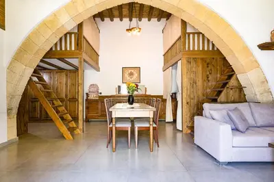 a living room with a table and a couch at To Kamariko in Soroni