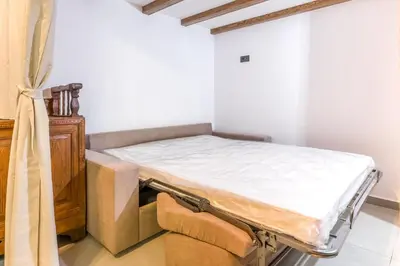 a hospital bed in a room with a window at To Kamariko in Soroni