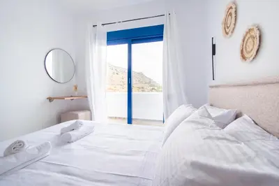 a bedroom with a bed with a view of the ocean at Sia Villa in Lardos