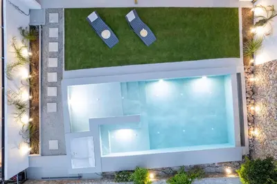 an overhead view of a swimming pool with a lawn at Sia Villa in Lardos