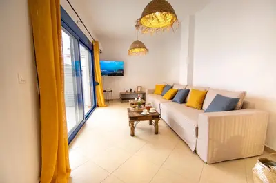 a living room with a couch and a table at Sia Villa in Lardos