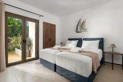 a bedroom with a large bed and a sliding glass door at Casa Stefania in Faliraki
