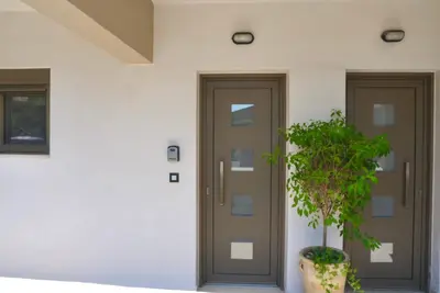 a plant in a pot in front of a door at Casa Stefania in Faliraki