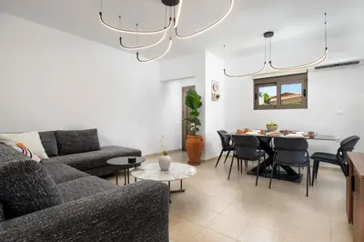 a living room with a couch and a table at Casa Stefania in Faliraki
