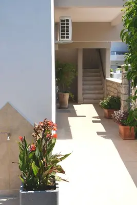 a building with some flowers in a courtyard at Casa Stefania in Faliraki