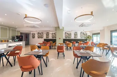 a dining room with tables and chairs at Philia Center Suites in Rhodes Town