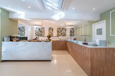 a large kitchen with a counter in a room at Philia Center Suites in Rhodes Town