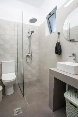 a bathroom with a shower and a toilet and a sink at GK Home Studios part of GK FITNESS CLUB in Faliraki