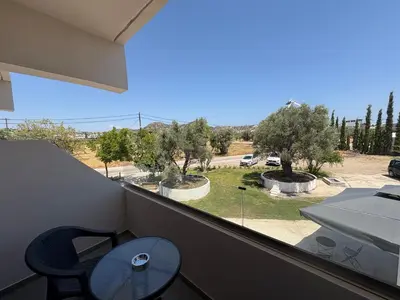 a balcony with a table and a view of a park at GK Home Studios part of GK FITNESS CLUB in Faliraki
