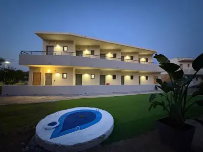 a large house with a swimming pool in front of it at GK Home Studios part of GK FITNESS CLUB in Faliraki