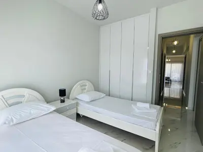 two white beds in a room with a mirror at Anastasia House in Afantou
