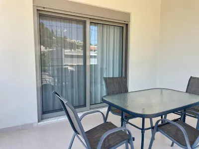 a table and chairs in a room with a window at Anastasia House in Afantou