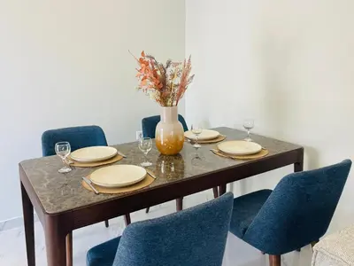 a dining room table with chairs and a vase with flowers at Anastasia House in Afantou