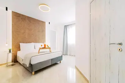 a bedroom with a bed with a table on it at Adama Luxury Villa in Kremasti