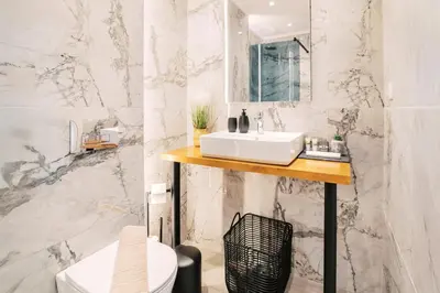 a white bathroom with a sink and a toilet at Adama Luxury Villa in Kremasti
