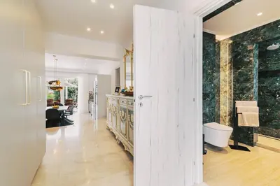 a kitchen and living room with a sliding door at Adama Luxury Villa in Kremasti